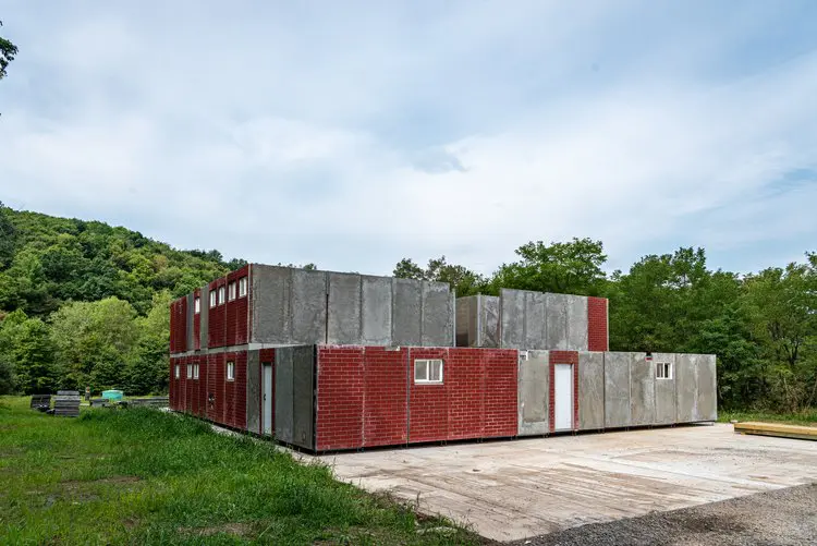 An under construction house with an open field in red