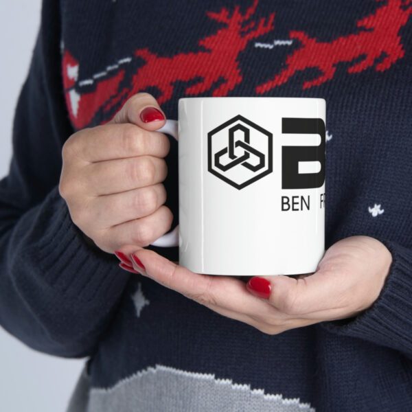 A woman holding a BFR Logo - Ceramic Mug 11oz with the word ben in it.