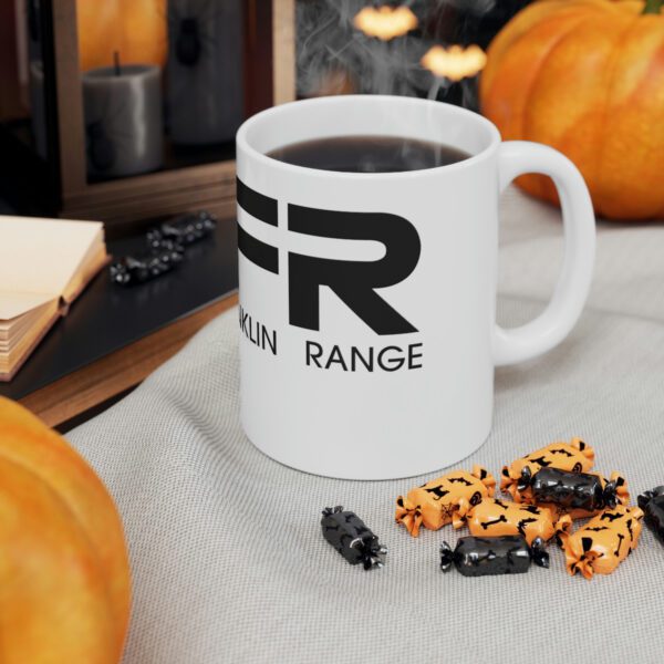 A BFR Logo - Ceramic Mug 11oz with the word fr on it next to some pumpkins.