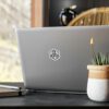 A laptop sits on a table next to a plant and a notebook, adorned with BFR Hex Logo - Vinyl Die-Cut Stickers.