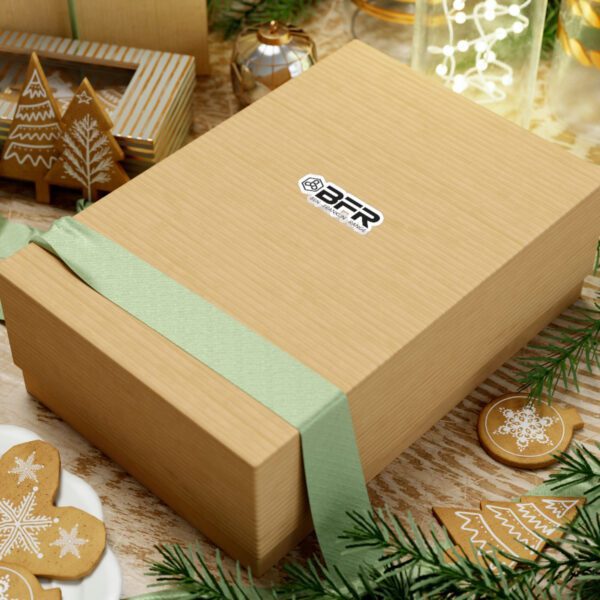 A Christmas gift box sitting on a table, adorned with BFR Logo - Vinyl Die-Cut Stickers, alongside delicious gingerbread cookies.