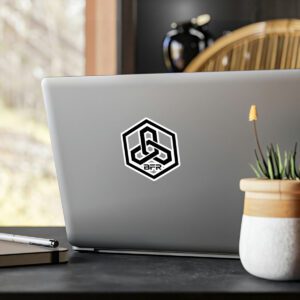 A BFR Hex Logo - Vinyl Die-Cut Stickers adorned laptop is sitting on a table next to a plant.