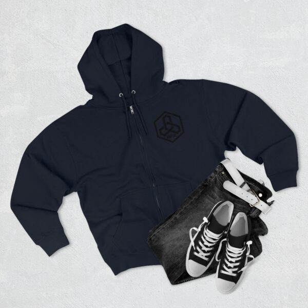 A black BFR Hex Logo - Unisex Premium Full Zip Hoodie paired with sneakers and jeans.