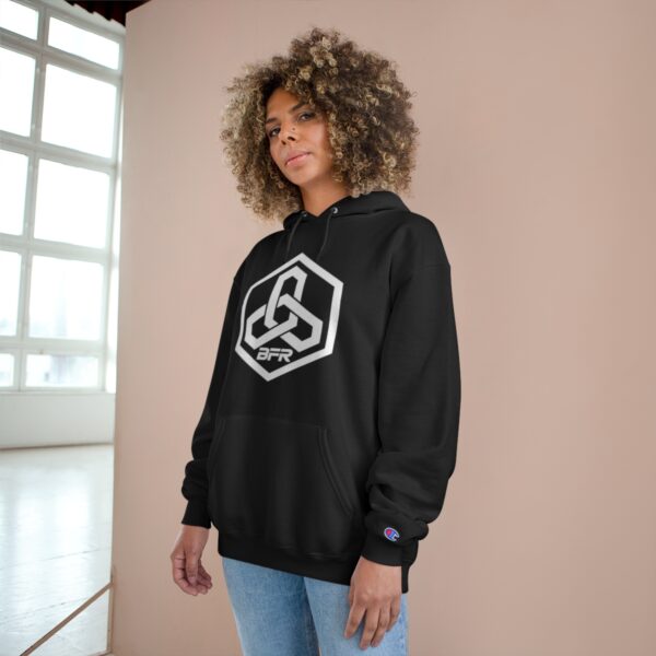 A woman wearing a BFR Hex Logo - Champion Hoodie with a peace symbol on it.