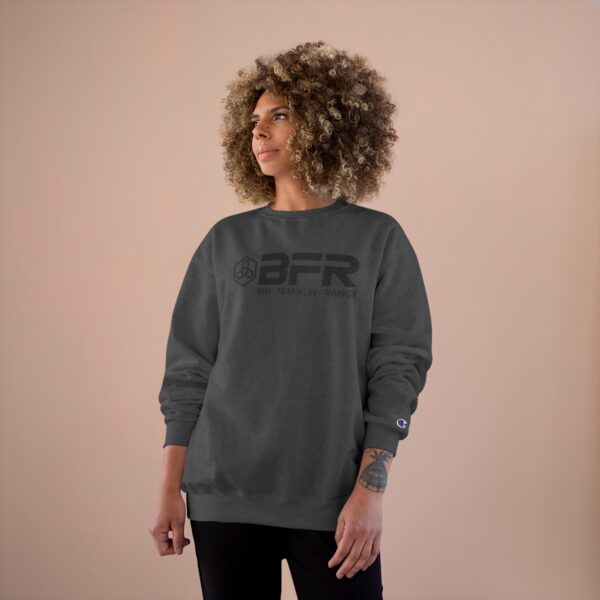 A woman wearing a grey BFR Logo - Champion sweatshirt.