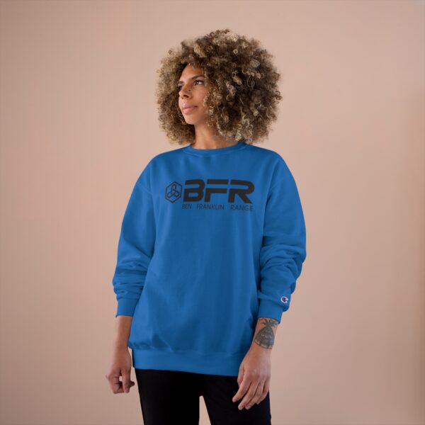 A woman wearing a blue BFR Logo - Champion Sweatshirt.