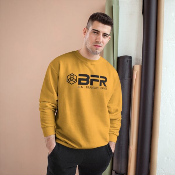 A man wearing a yellow BFR Logo - Champion Sweatshirt.