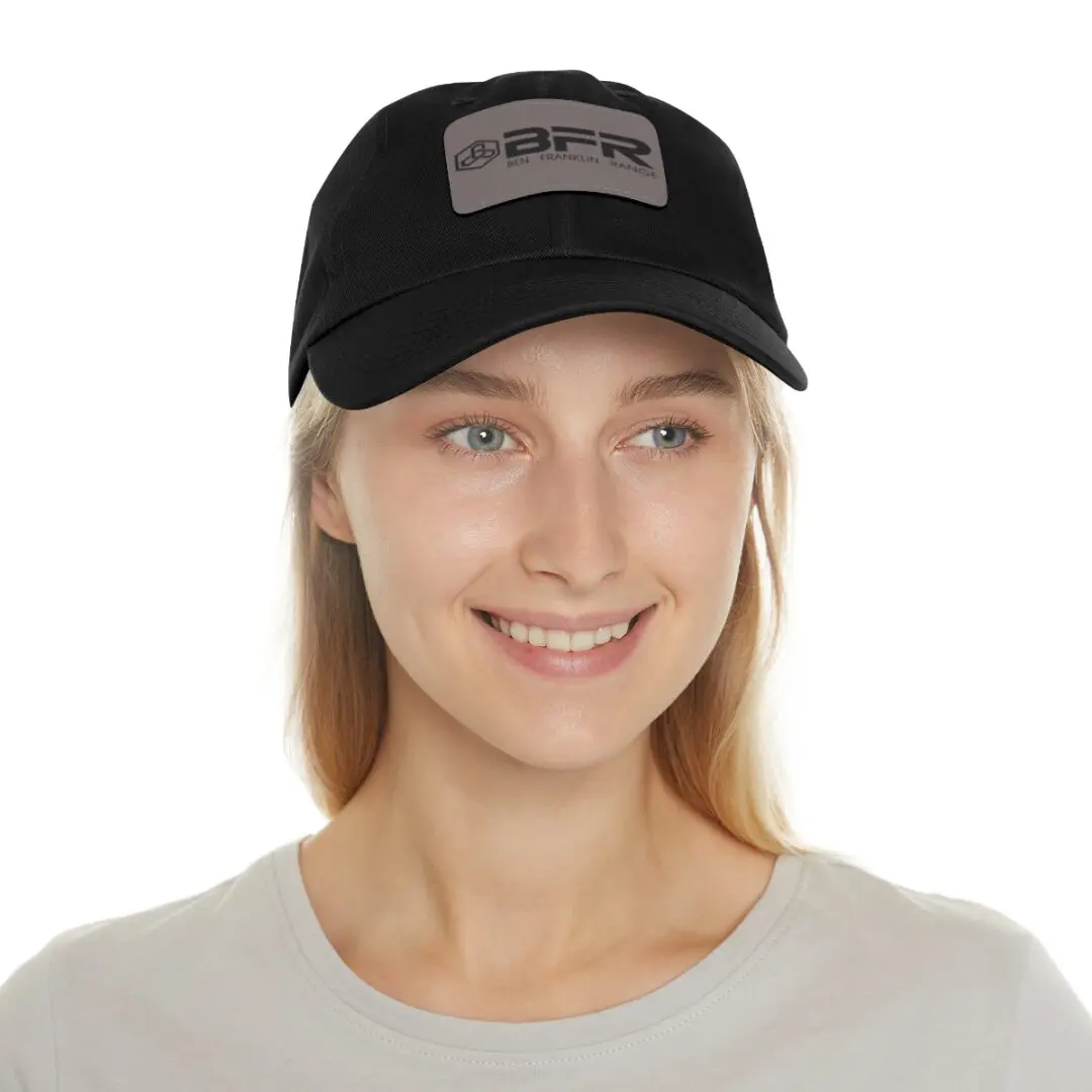 A woman wearing a BFR Logo - Dad Hat with Leather Patch (Rectangle) on it.
