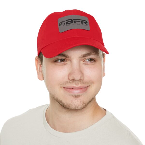 A man wearing a red BFR Logo - Dad Hat with Leather Patch (Rectangle) hat.