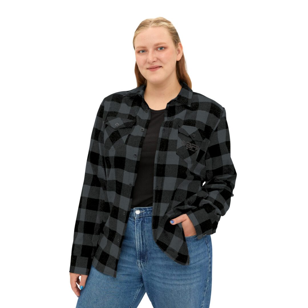 A woman wearing a BFR Logo - Unisex Flannel Shirt. A woman wearing a BFR Logo - Unisex Flannel Shirt.