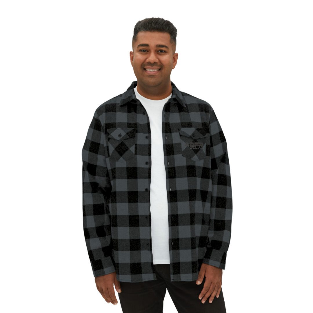 A man wearing a BFR Logo - Unisex Flannel Shirt in black and grey plaid. A man wearing a BFR Logo - Unisex Flannel Shirt in black and grey plaid.