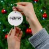 A person holding a BFR Logo - Ceramic Ornament, 4 Shapes with the word bfr on it.