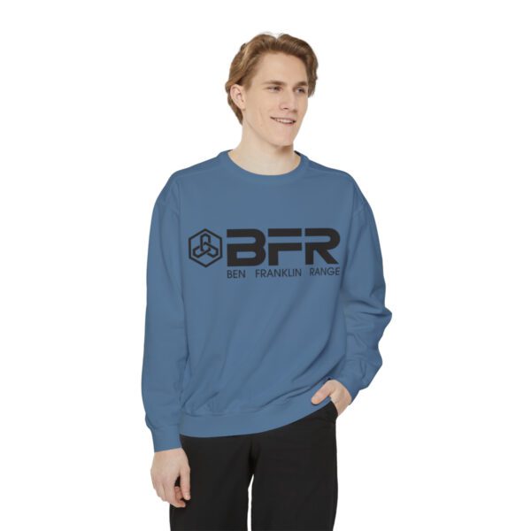 A man wearing a BFR Logo - Unisex Garment-Dyed Sweatshirt in blue.