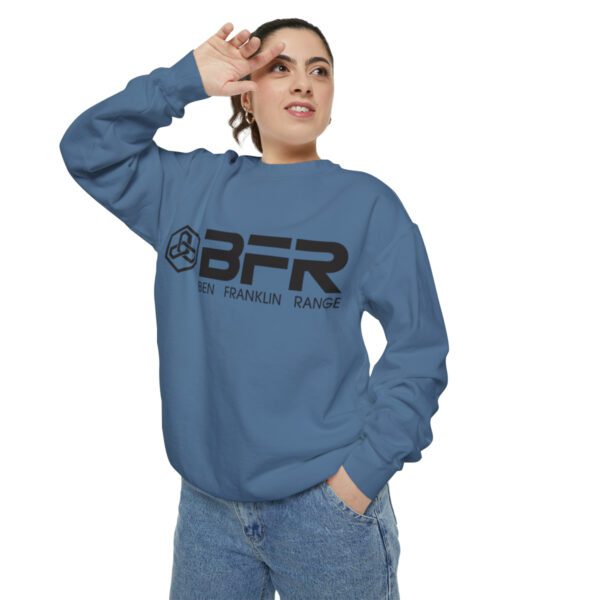 A woman wearing a blue BFR Logo - Unisex Garment-Dyed Sweatshirt with the word bfr on it.