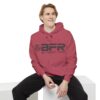 A man wearing a red BFR Logo - Unisex Garment-Dyed Hoodie.