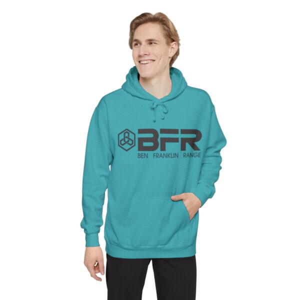 A man wearing a BFR Logo - Unisex Garment-Dyed Hoodie with the word bfr on it.