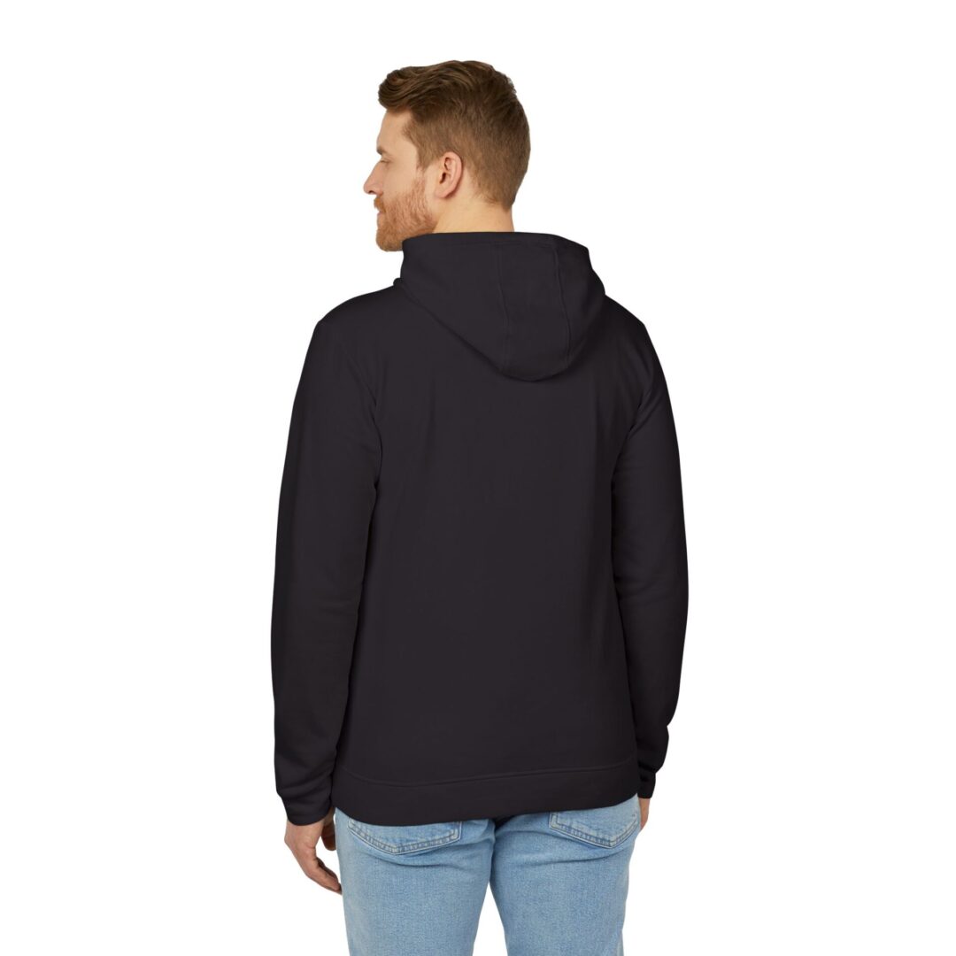 Man wearing black hoodie, light jeans, back view.