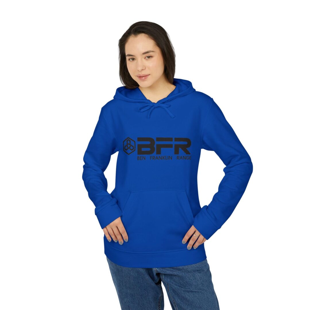 Woman wearing blue BFR hoodie, hands in pockets.