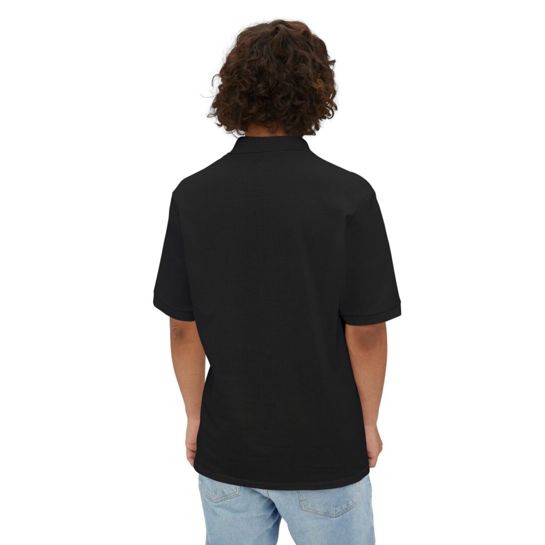 Person in black shirt and jeans, back view.