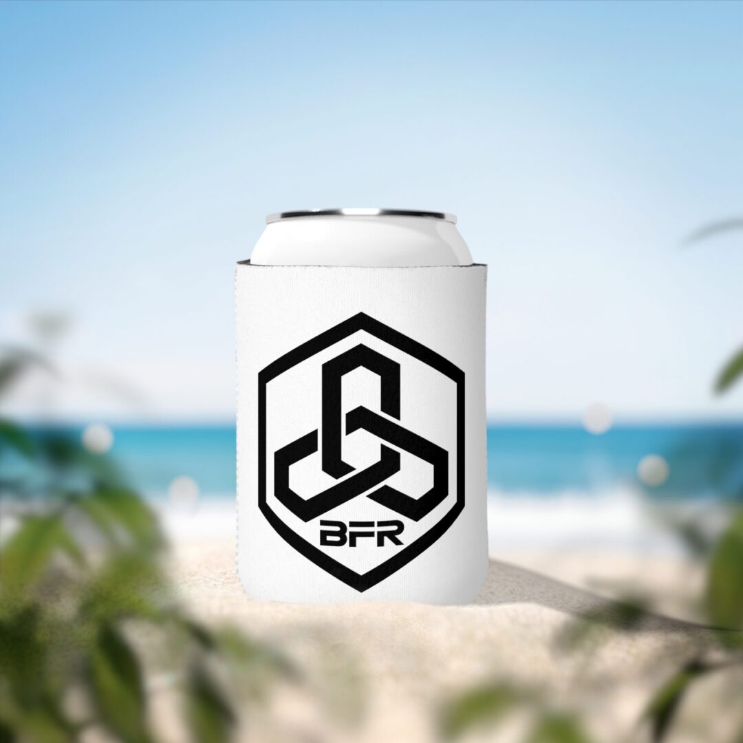 Drink can on sandy beach, ocean background.