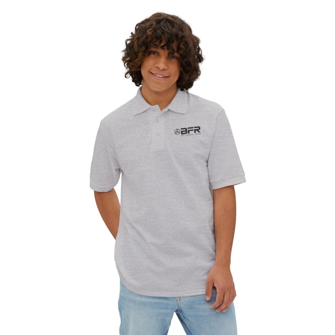 Young person in gray logo polo shirt.