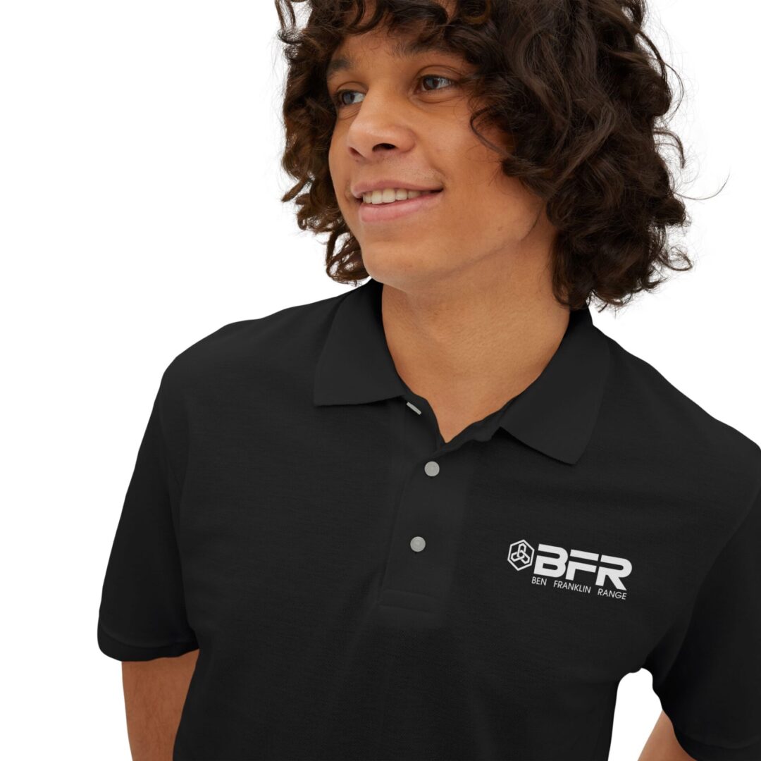 Smiling person in black BFR polo shirt.