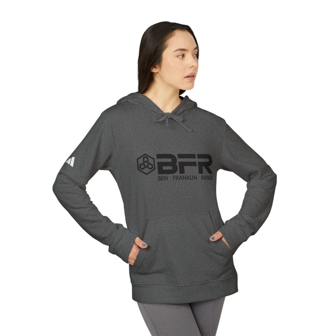 Person wearing gray BFR hoodie, hands in pockets.