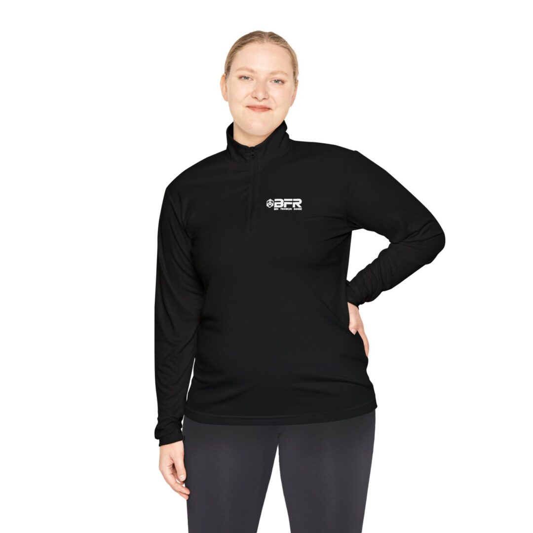 Woman in black quarter-zip pullover.