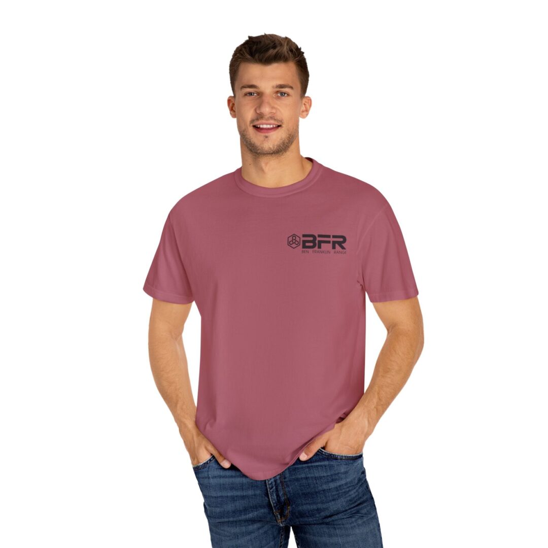Man wearing pink T-shirt with logo. Man wearing pink T-shirt with logo.