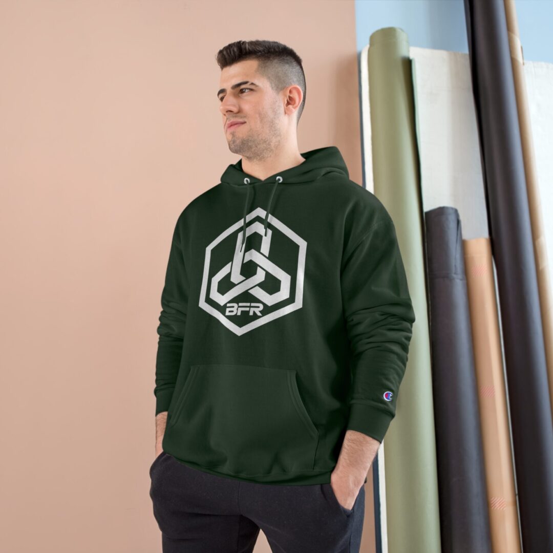 Man wearing green hoodie with geometric logo.