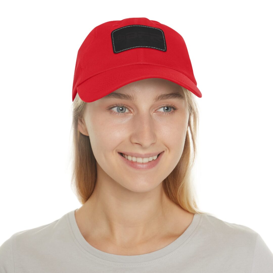 Smiling person wearing red baseball cap.