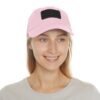 Smiling person wearing a pink baseball cap.
