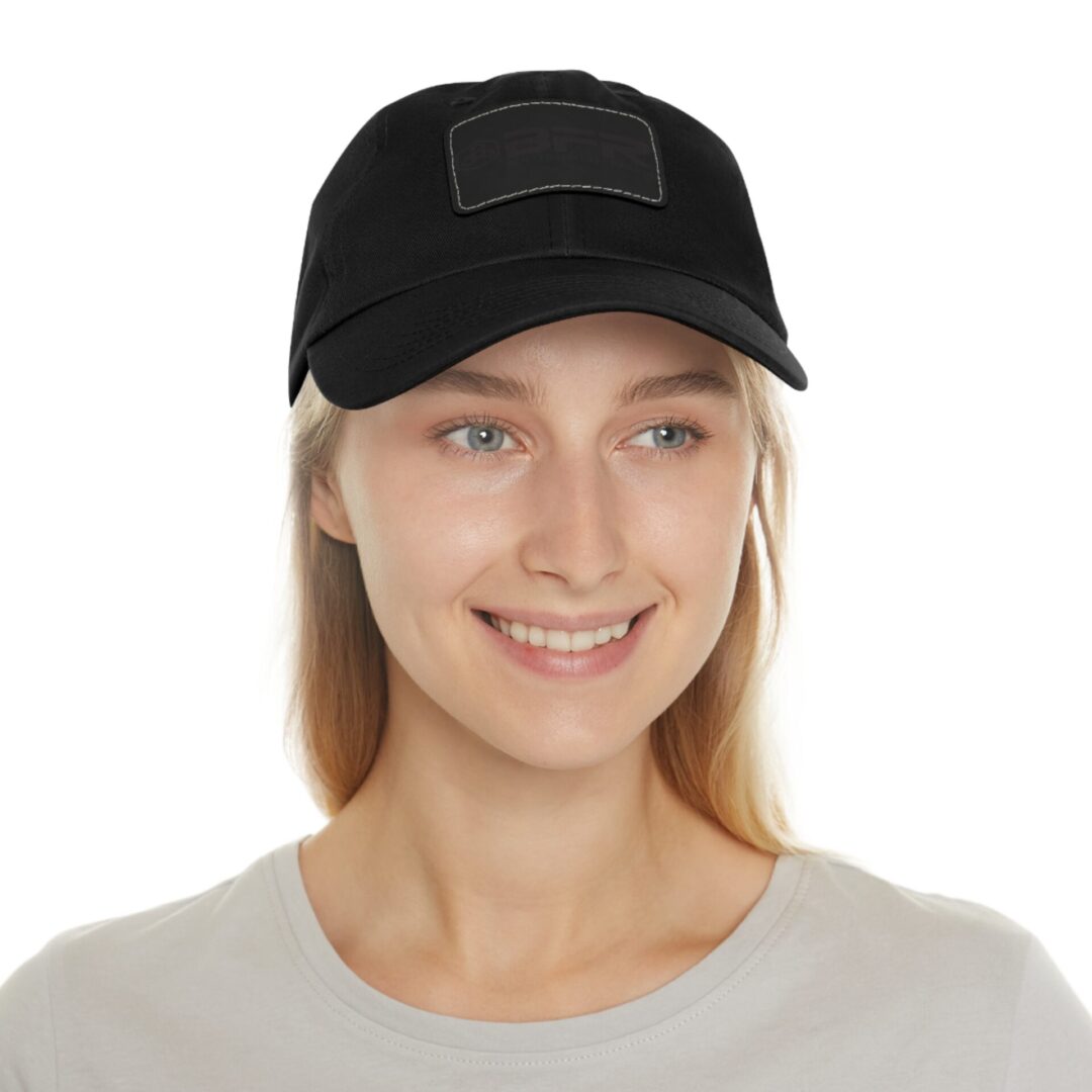 Person smiling, wearing black cap.