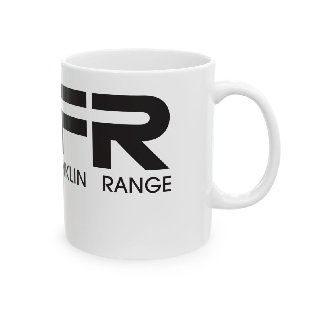 White mug with black text partially visible.