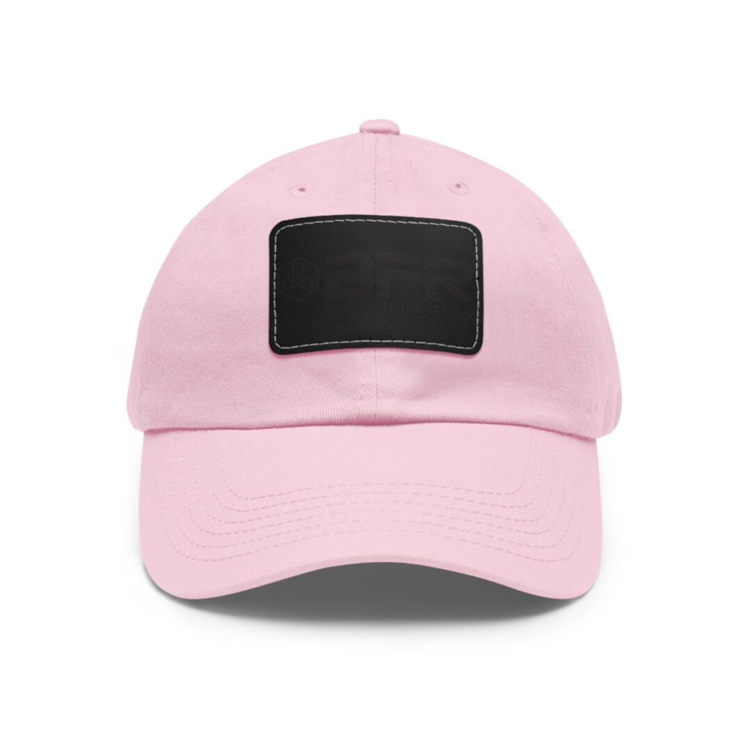 Pink baseball cap with black patch.