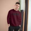 Man wearing maroon sweater, standing indoors. Man wearing maroon sweater, standing indoors.