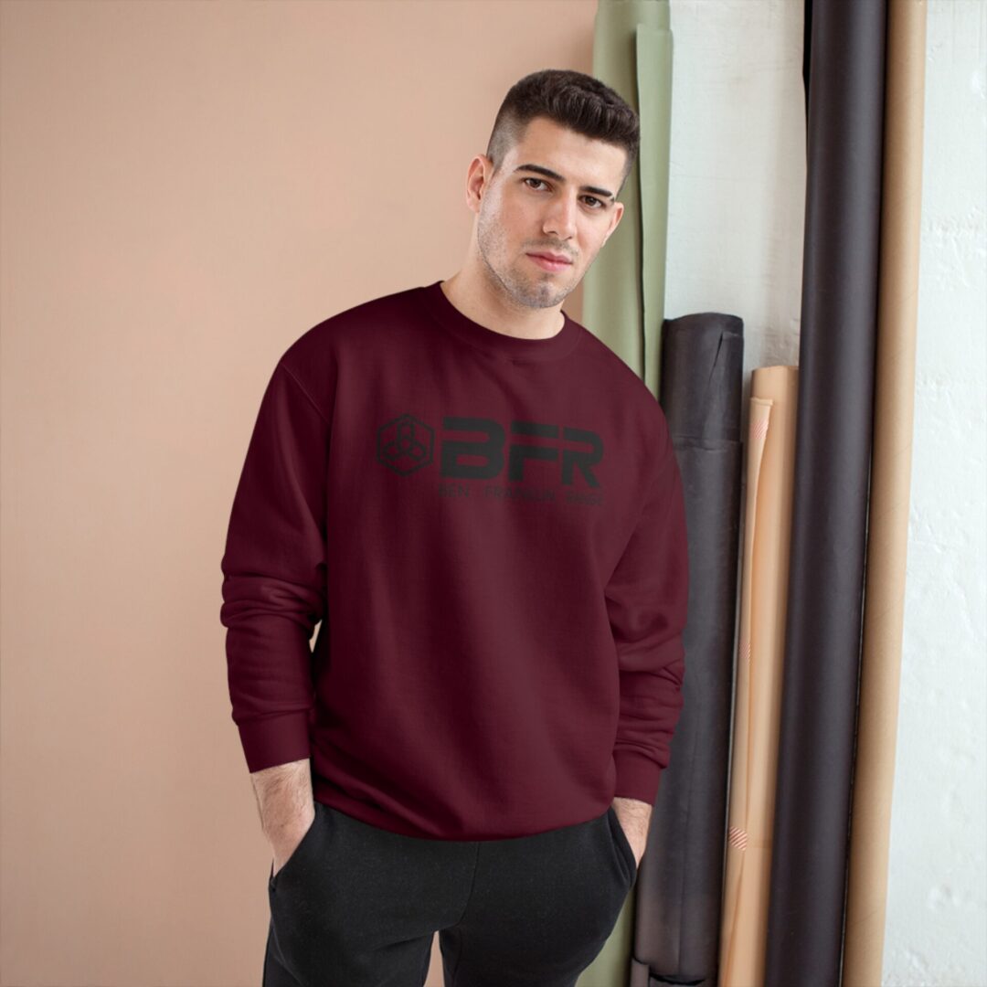 Man wearing maroon sweater, standing indoors. Man wearing maroon sweater, standing indoors.
