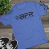 Blue BFR t-shirt on wooden surface.