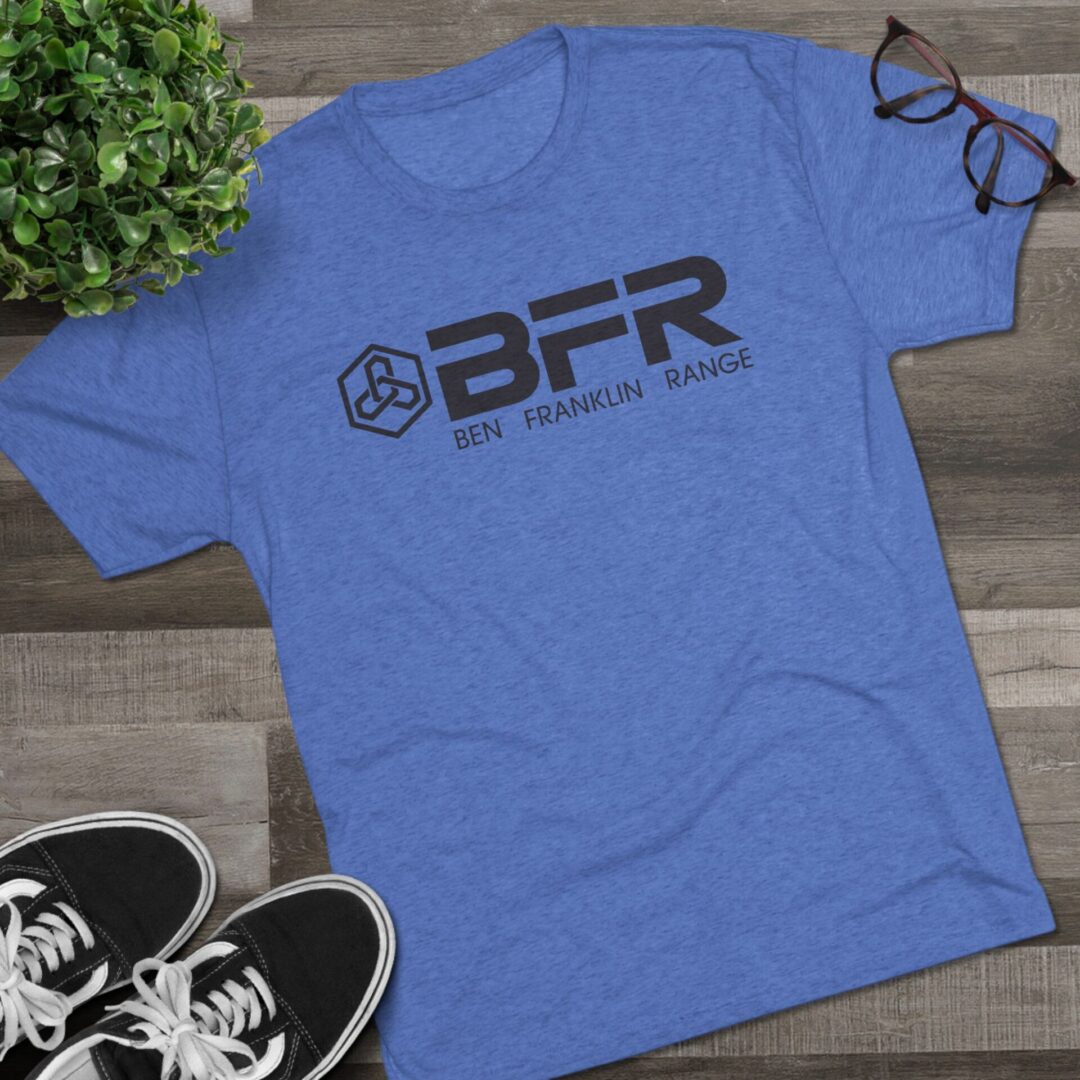 Blue BFR t-shirt on wooden surface.