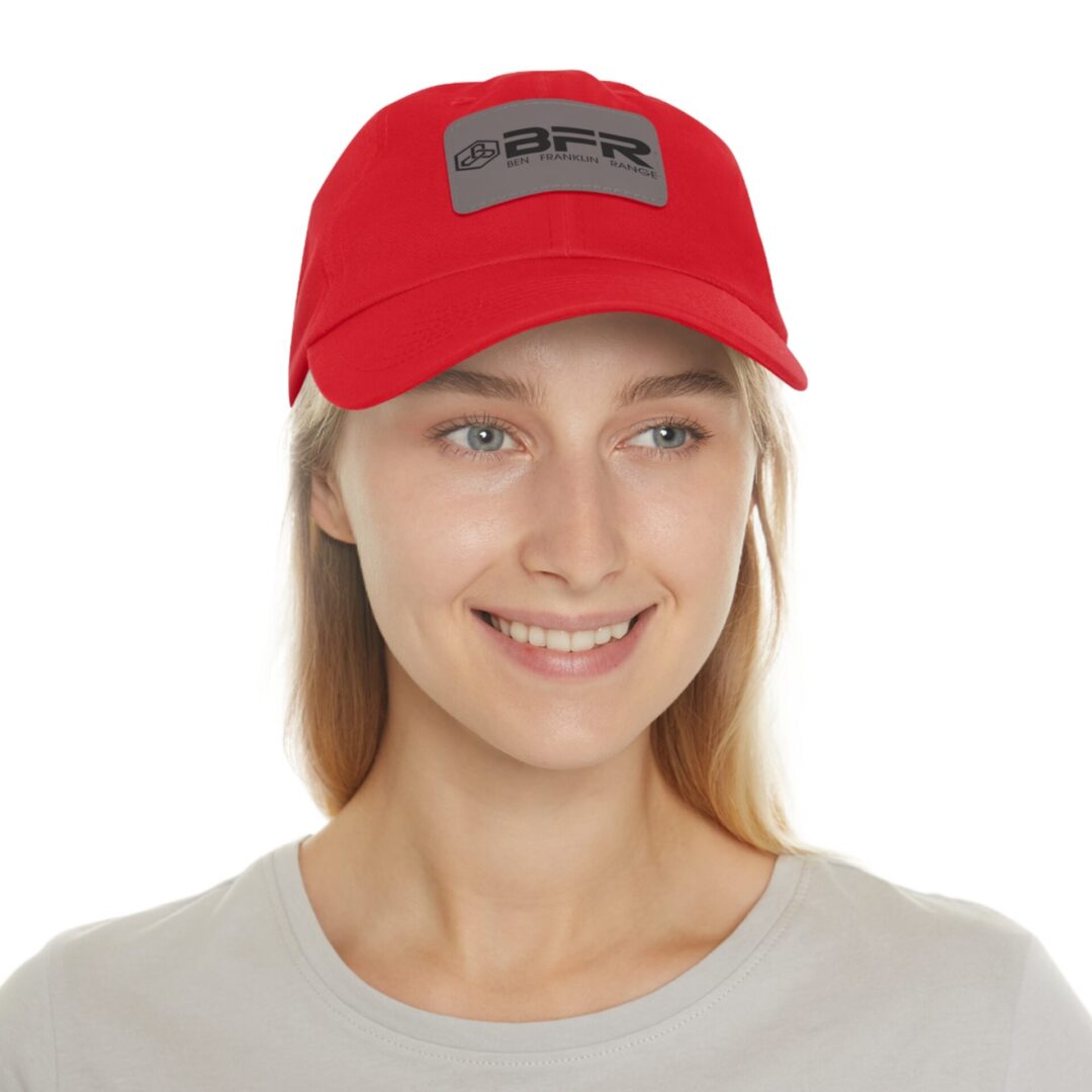 Person wearing red cap, smiling at camera.