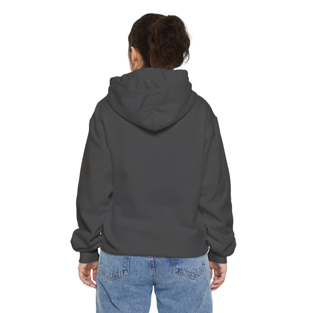 Person wearing hoodie and jeans, facing away.