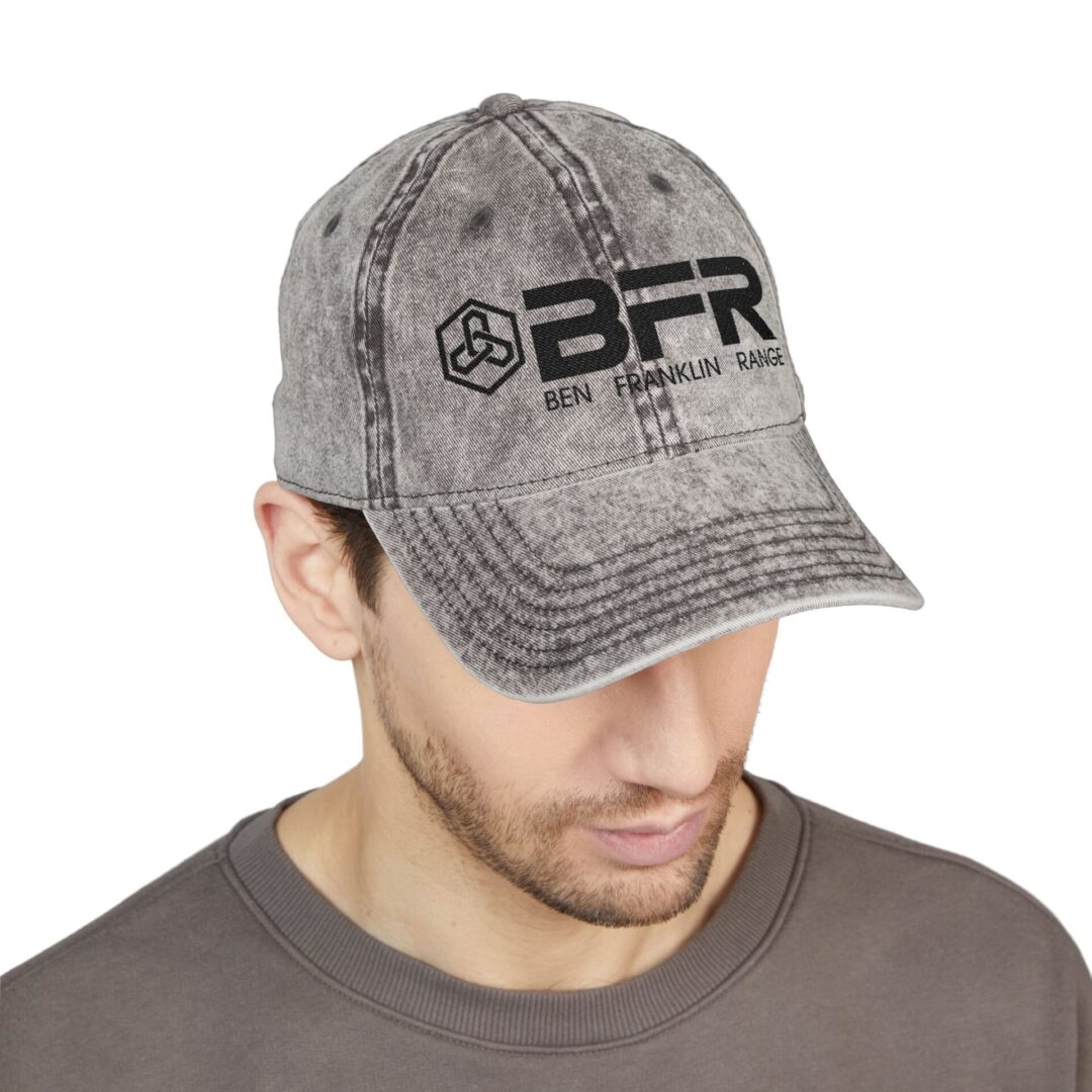 Man wearing a gray cap, head down.