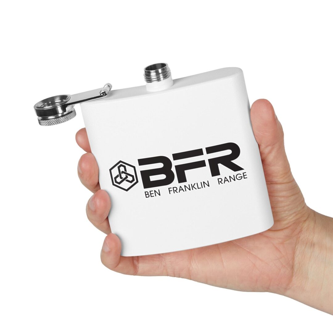 Hand holding a white flask with logo.