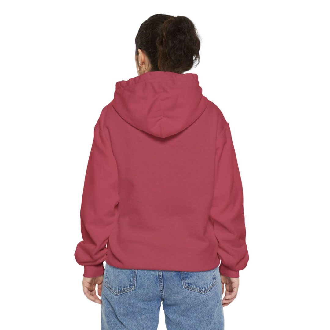 Child in red hoodie and jeans, back view.
