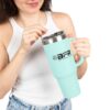 Woman holding large blue travel mug.