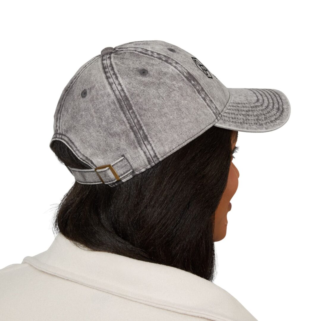 Person wearing a gray denim baseball cap.