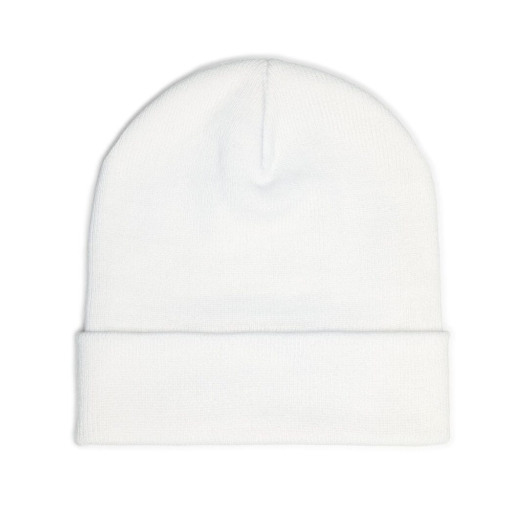 White knit beanie on plain background.